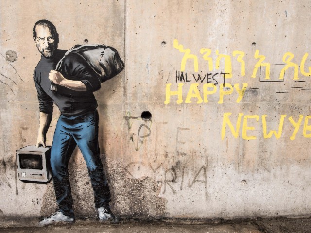 A photo of 'Son of a Migrant from Syria' mural by Banksy